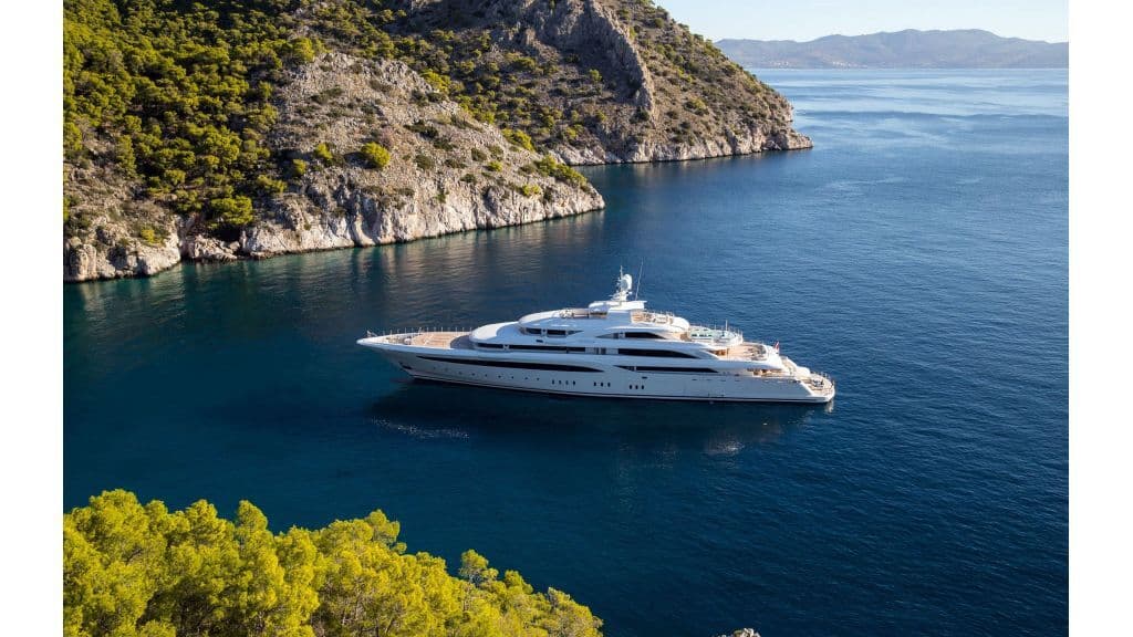 Mega yacht at anchor in a rocky Riviera cove